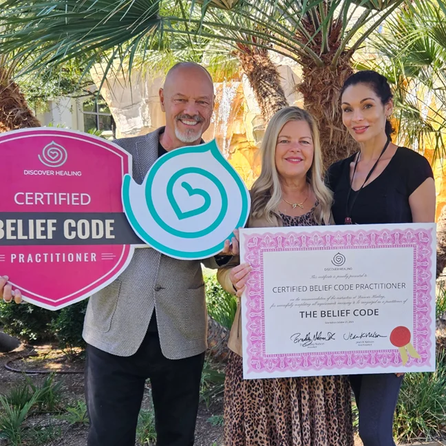 Makayla Léone receiving her Certified Belief Code Practitioner certificate with Dr. Bradley and Jean Nelson, 2023